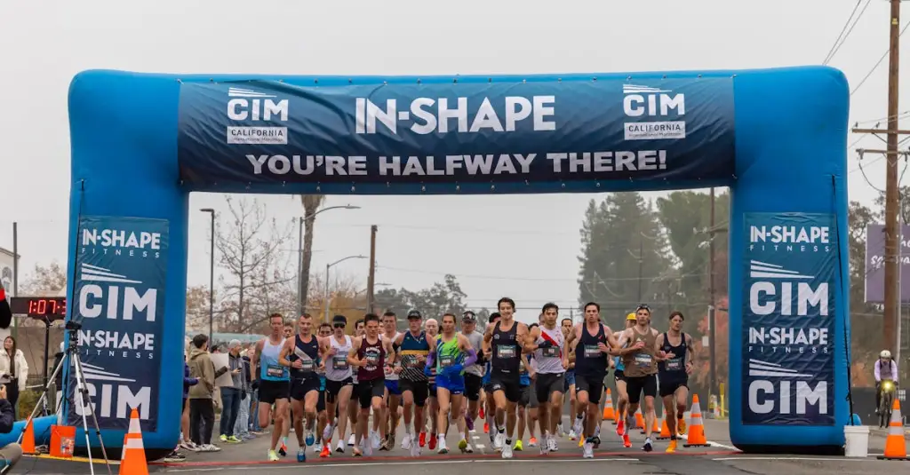 A group of recreational runners of mixed ages and fitness levels running together on a trail path through a green park, motion blur on feet, golden hour lighting, realistic sports photography