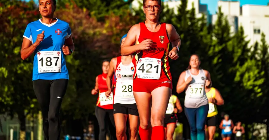 Group of recreational runners of different ages crossing the finish line of a road race in a Portuguese city, race bibs visible, crowd cheering, dynamic motion blur, photorealistic sports event photography