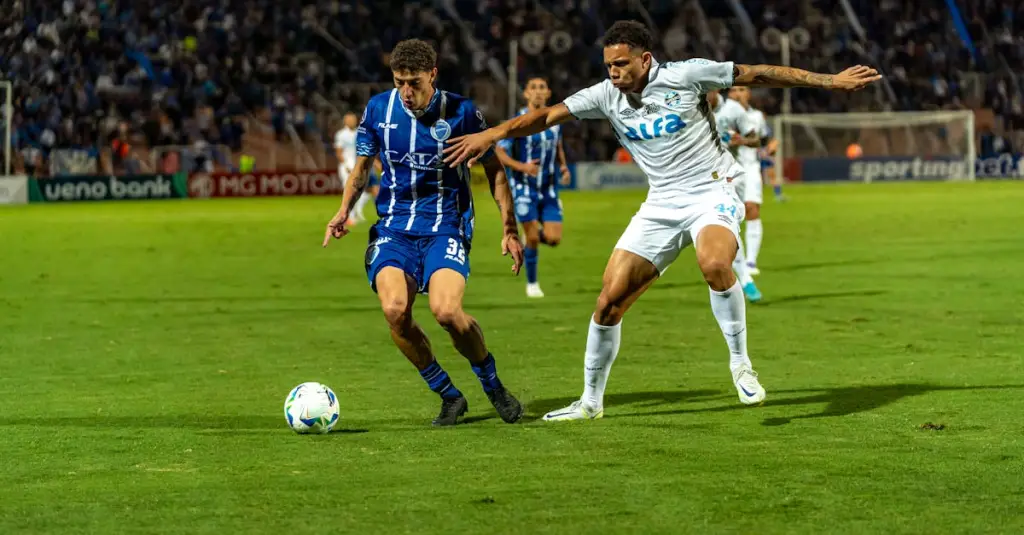 Professional football midfielder running at full speed on a pitch during a match, motion blur effect, stadium crowd in background, GPS tracking vest visible, realistic sports photography, dramatic lighting