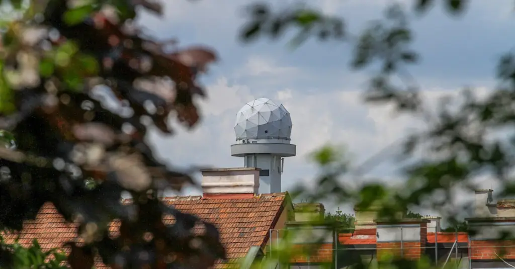 Close-up of a radar speed gun display showing tennis serve speed in km/h on a professional court, electronic scoreboard in background, photorealistic sports technology