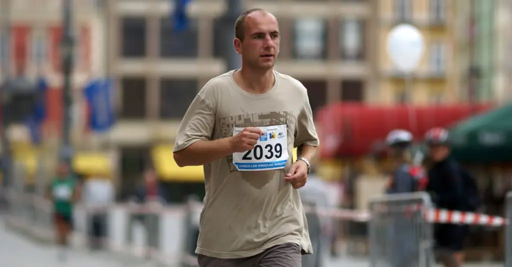 A male runner in his 30s jogging through a Portuguese city street at dawn, wearing a GPS running watch on his wrist, motion blur on legs, warm morning light, realistic sports photography, urban environment with cobblestone pavement