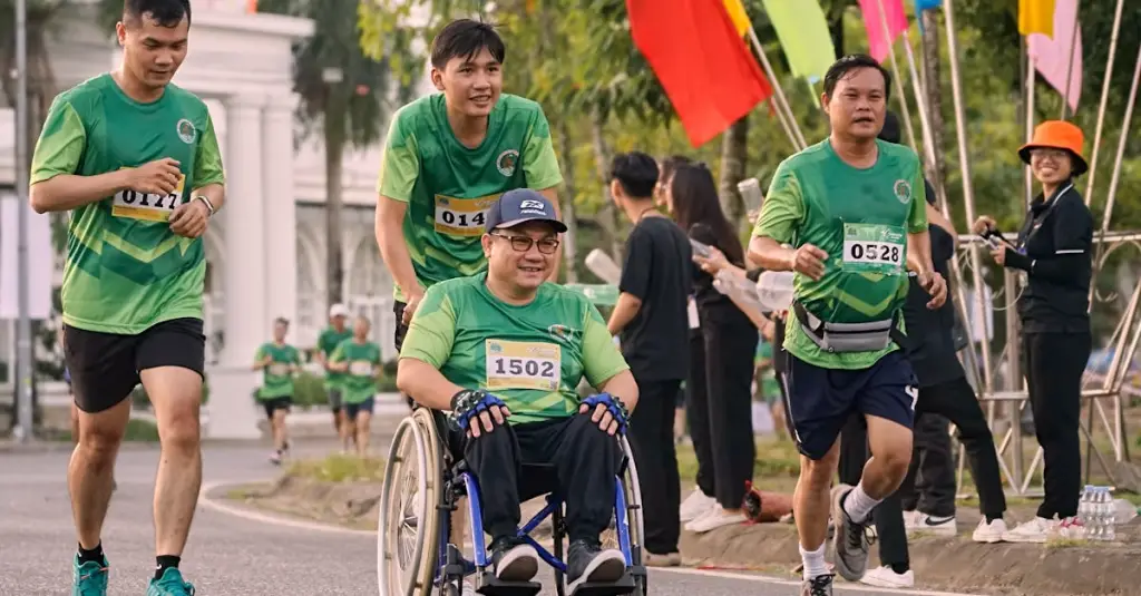 Diverse group of marathon runners passing the Cutty Sark in Greenwich during the London Marathon, cheering crowd lining the streets, bright spring morning, realistic sports photography
