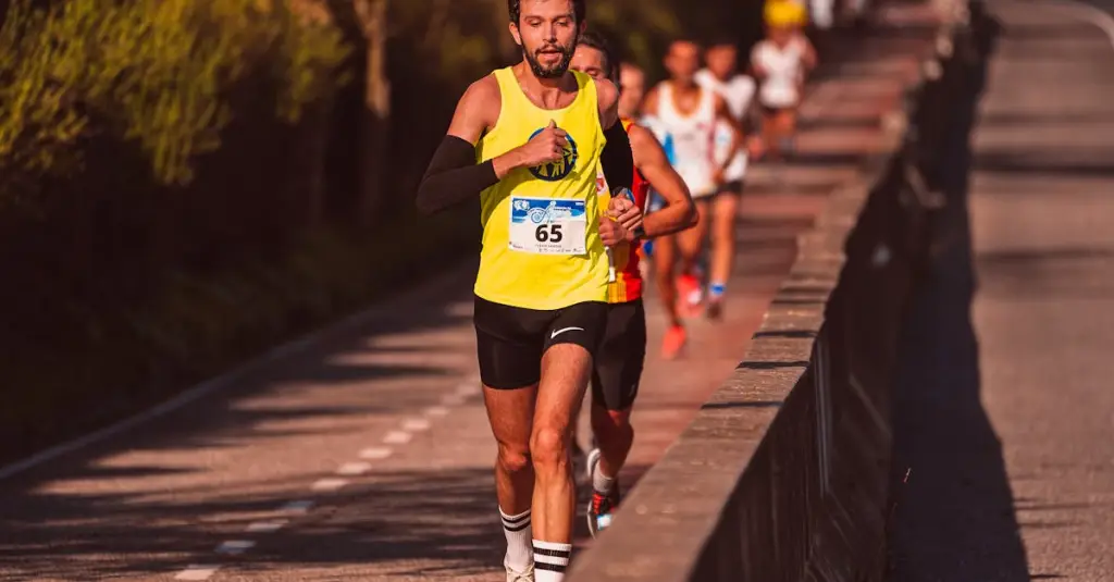 A Portuguese runner wearing race bib collecting marathon kit at an expo hall, race merchandise and London Marathon branding visible in background, realistic stock photo style
