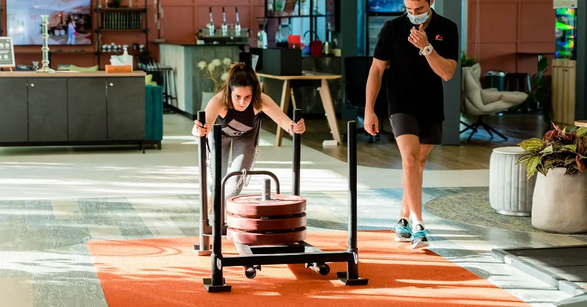 A fit woman performing a sled push exercise on an indoor track during a HYROX competition, low position, intense effort, competition bib visible, motion blur on legs, photorealistic sports action shot